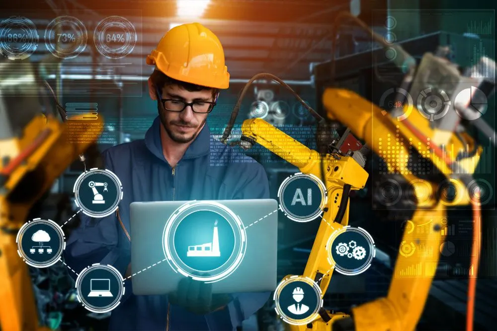 Engineer with a laptop beside robotic arms, surrounded by AI and data overlays